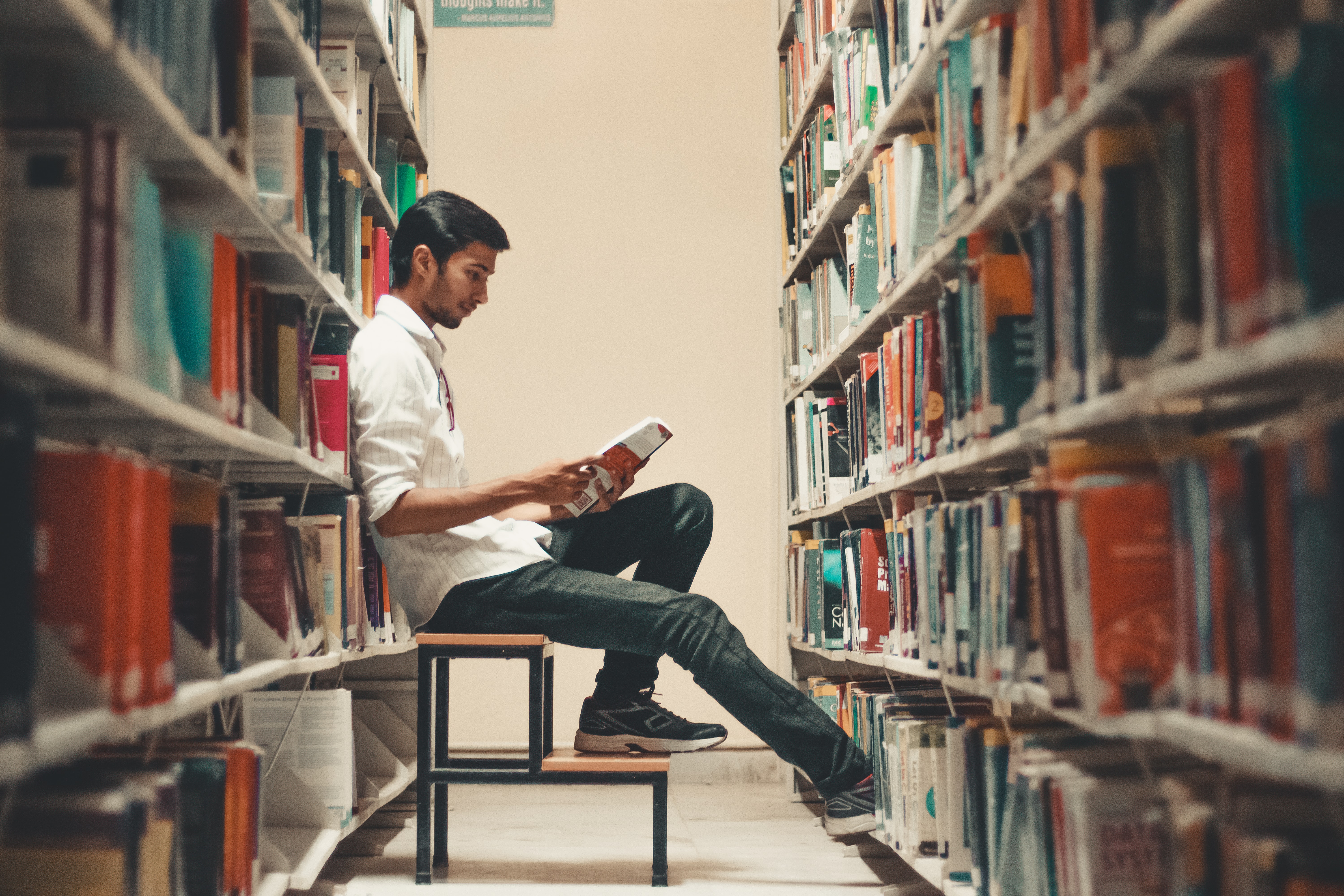 student sitting on chair in library 