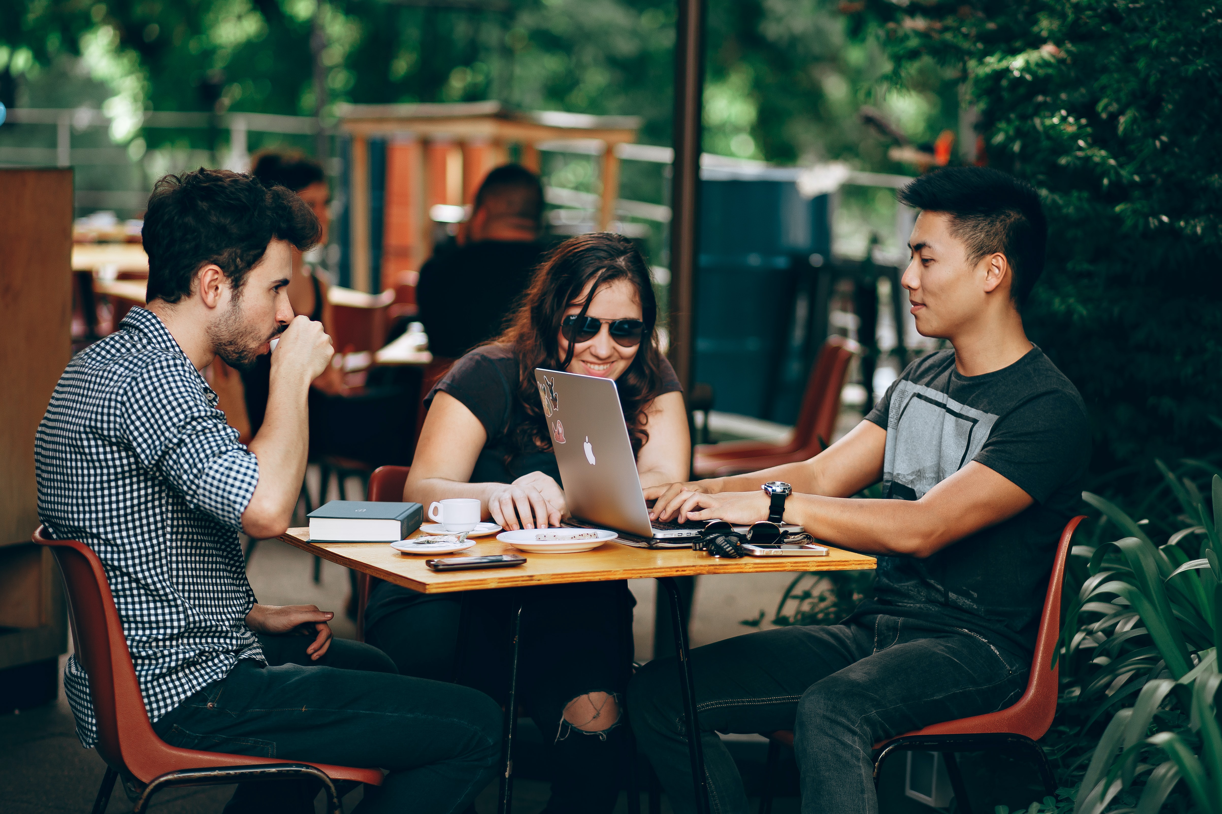 students at a table with laptops