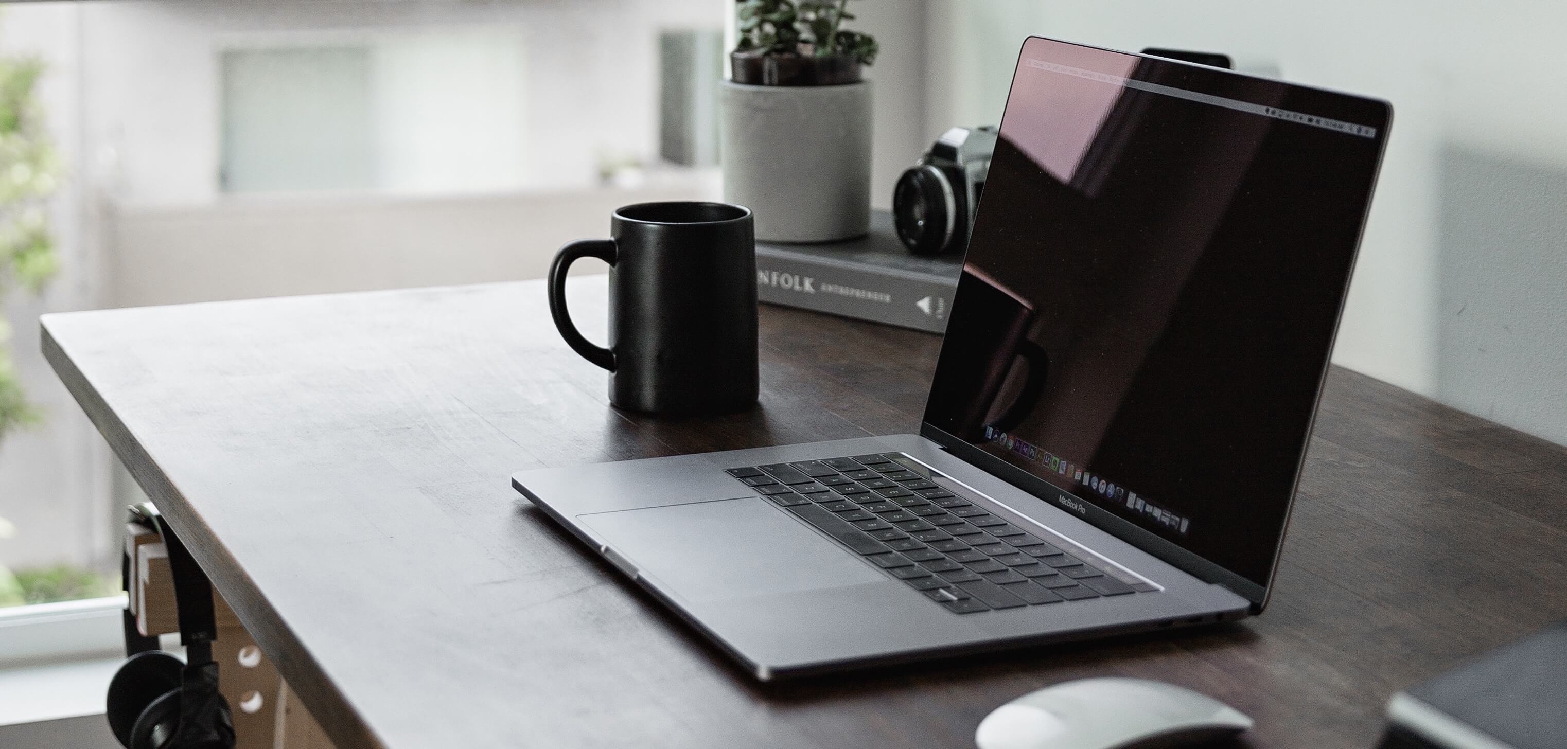 Image of laptop and coffee cup on desk